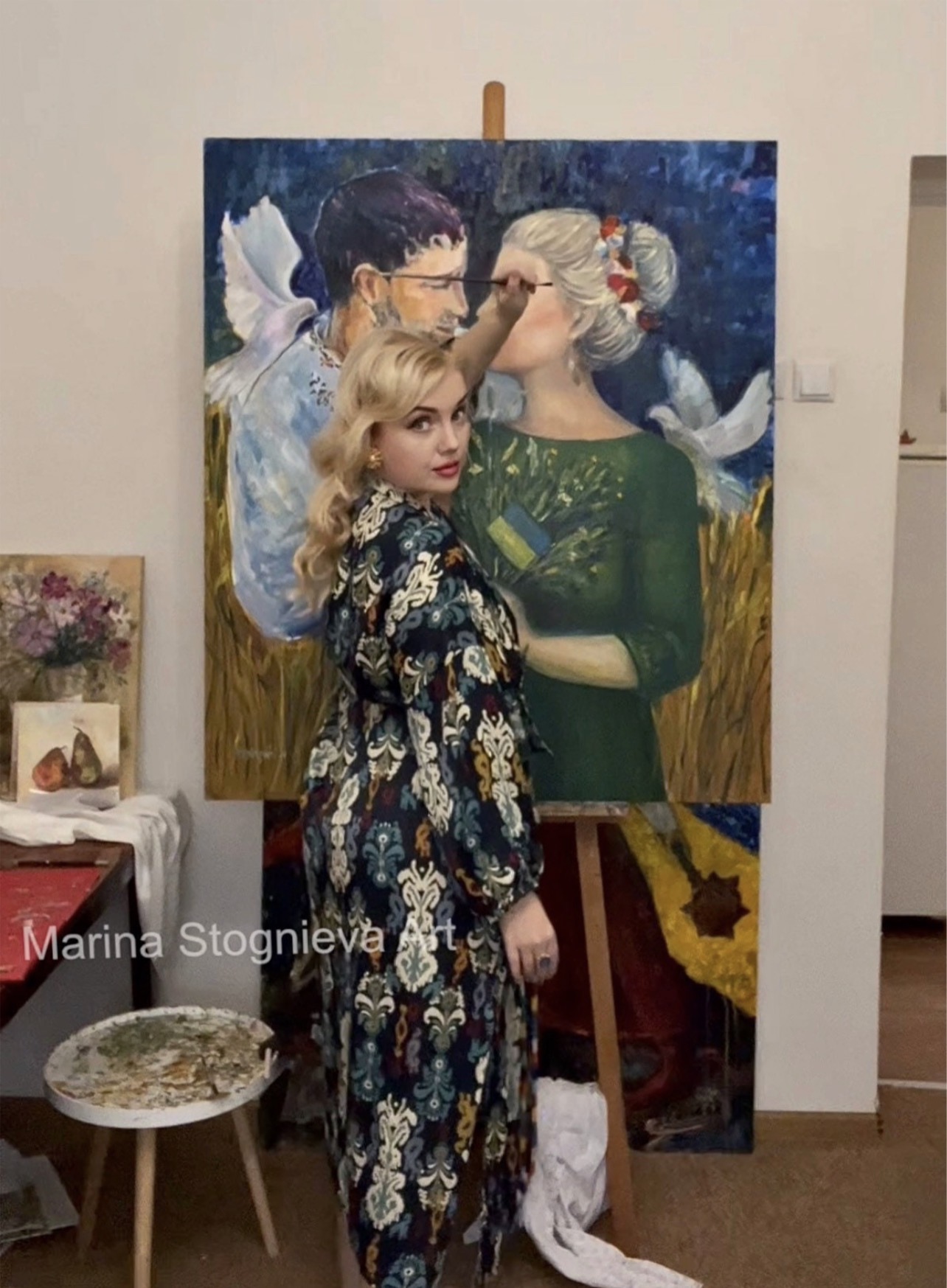 Ukrainian artist Marina Stognieva during the creation of the Ukrainian couple painting
